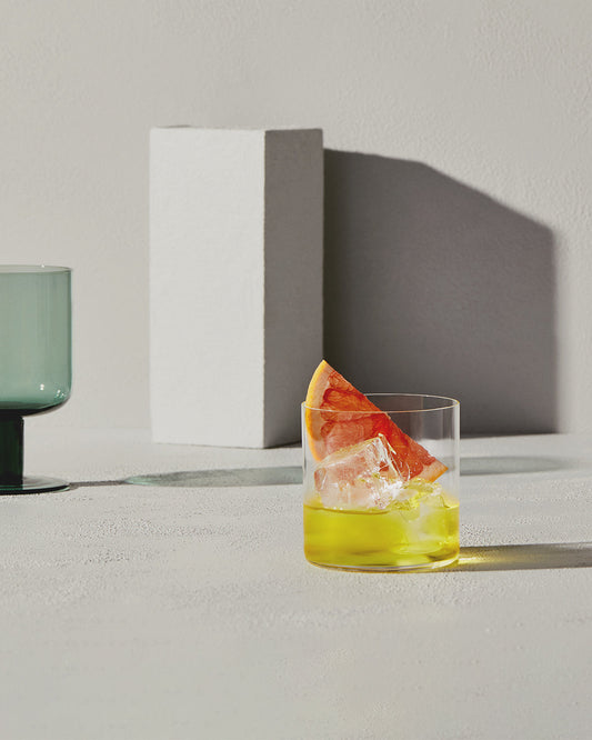 A white negroni cocktail made with Four Pillars Gin Rare Dry Gin, with a pink grapefruit garnish,