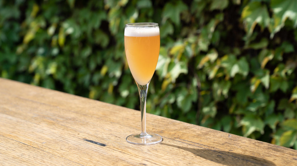 champagne flute filled with a refreshing gin cocktail made with Four Pillars Rare Dry Gin and topped with champagne