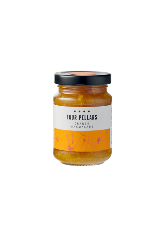 A jar of Four Pillars Orange Marmalade with a clear label and orange peel visible through the glass.