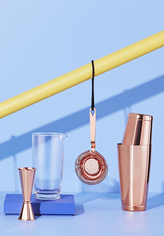 A stylish bar setup featuring copper cocktail shakers and barware, perfect for crafting exquisite cocktails.