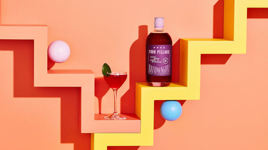 A fun photo of a bottle of non-alcoholic bloody shiraz gin and a red mocktail.
