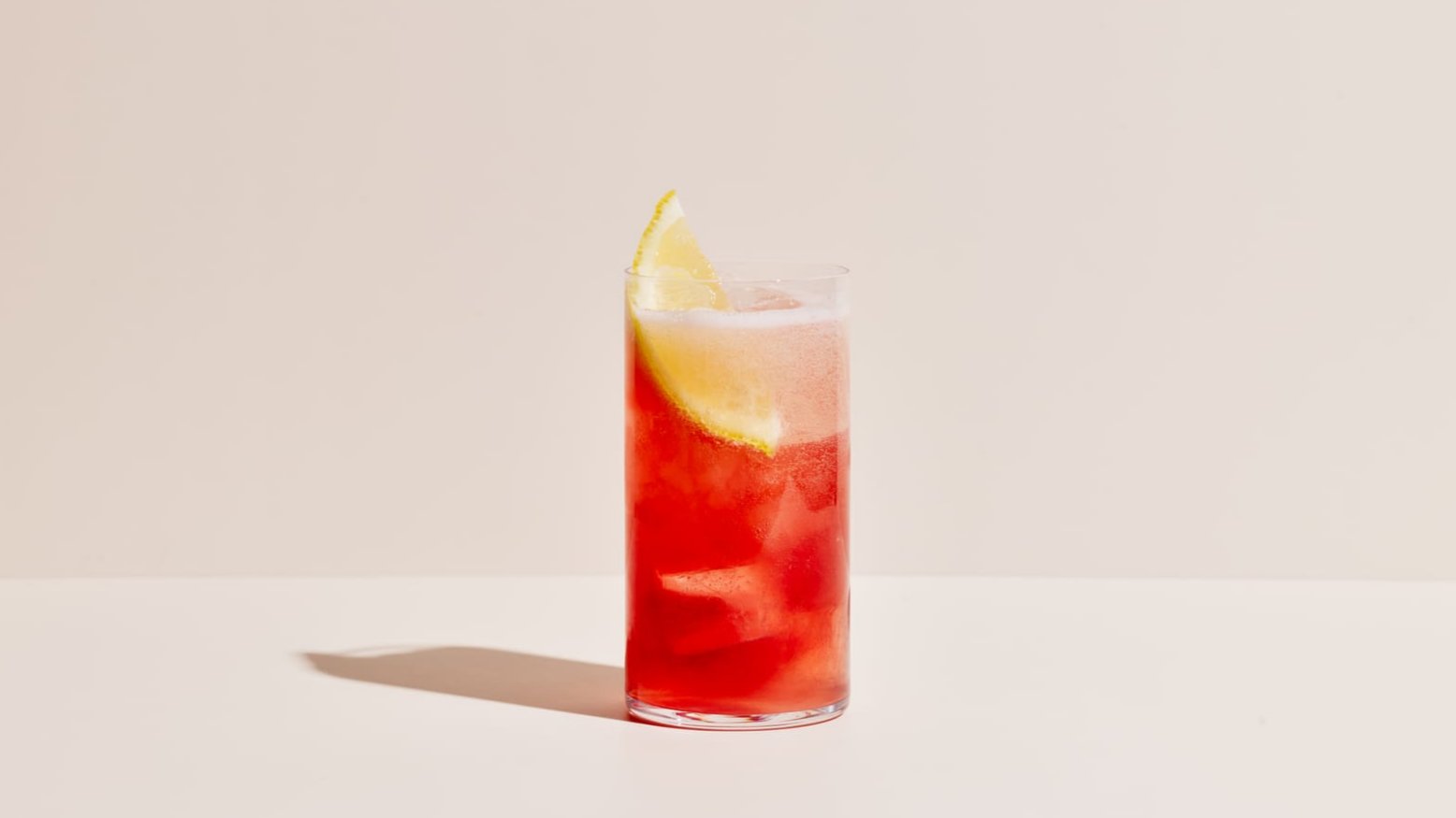 A fizzy cocktail in a tall glass containing Four Pillars Bloody Shiraz Gin