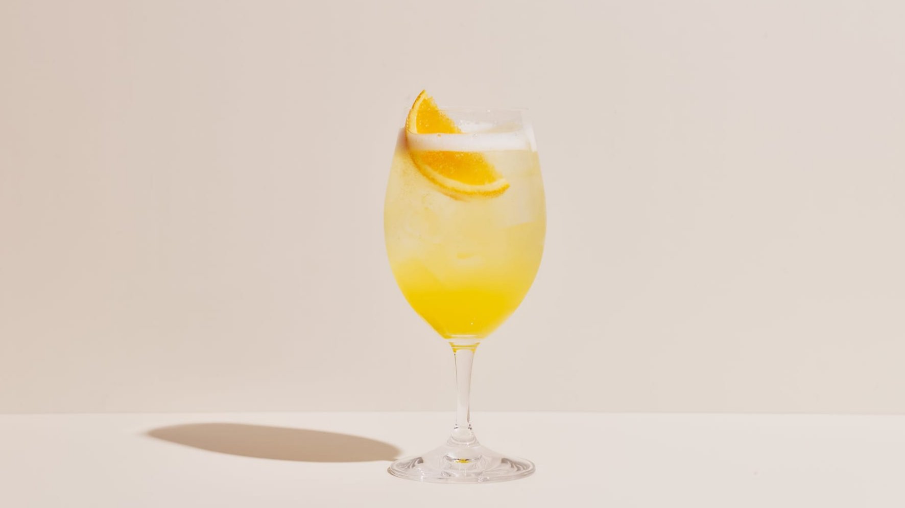 A mimosa made with Four Pillars Rare Dry Gin in a wine glass.