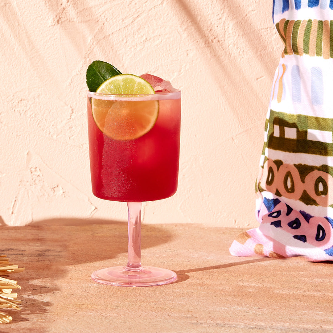 A pink cocktail glass filled with a Gin Spritz cocktail made with Four Pillars Bloody Shiraz Gin.