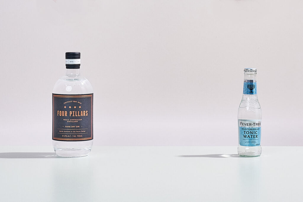 A bottle of Four Pillars Gin Rare Dry Gin standing next to it's perfect partner, a FeverTree Tonic. 