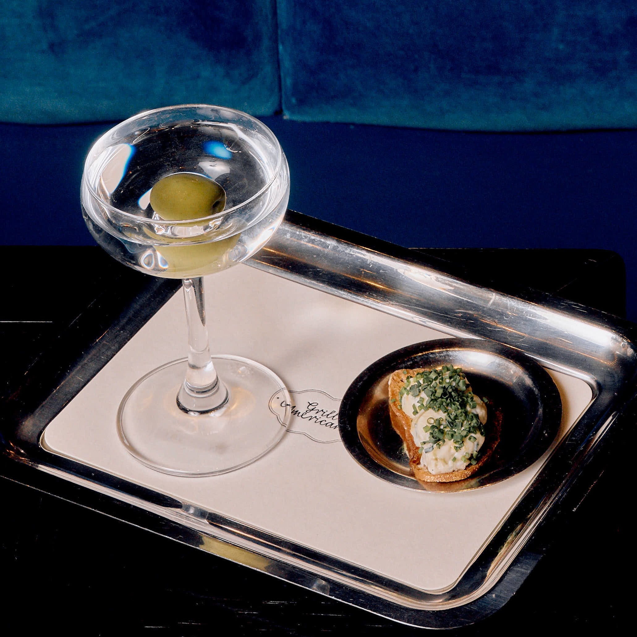 Grill Americano's mini Olive Leaf Gin Martini and olive crostini.