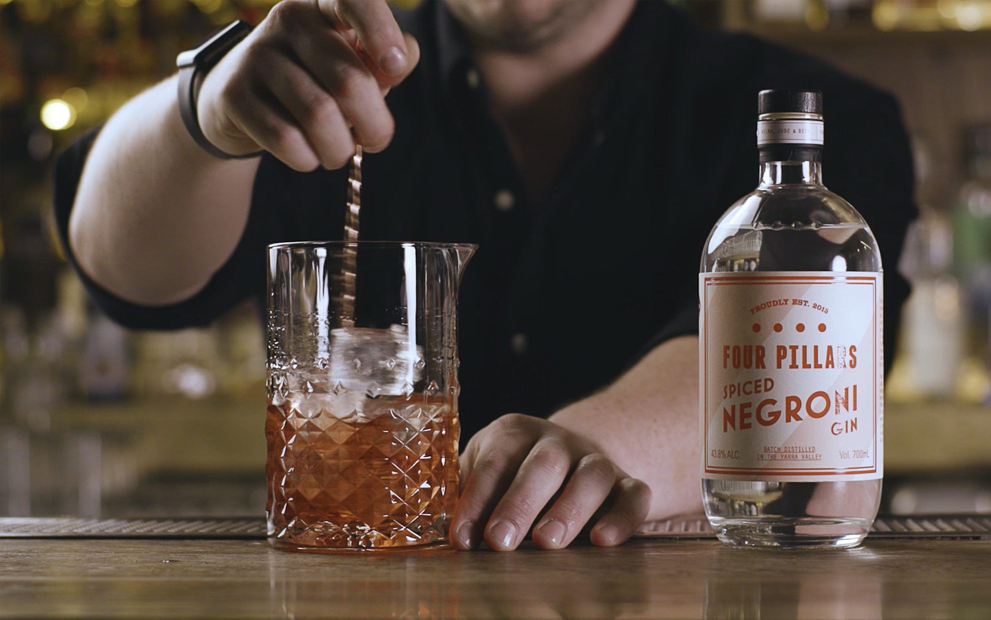 A bartended mixes a negroni cocktail with Four Pillars Gin's spiced Negroni Gin.