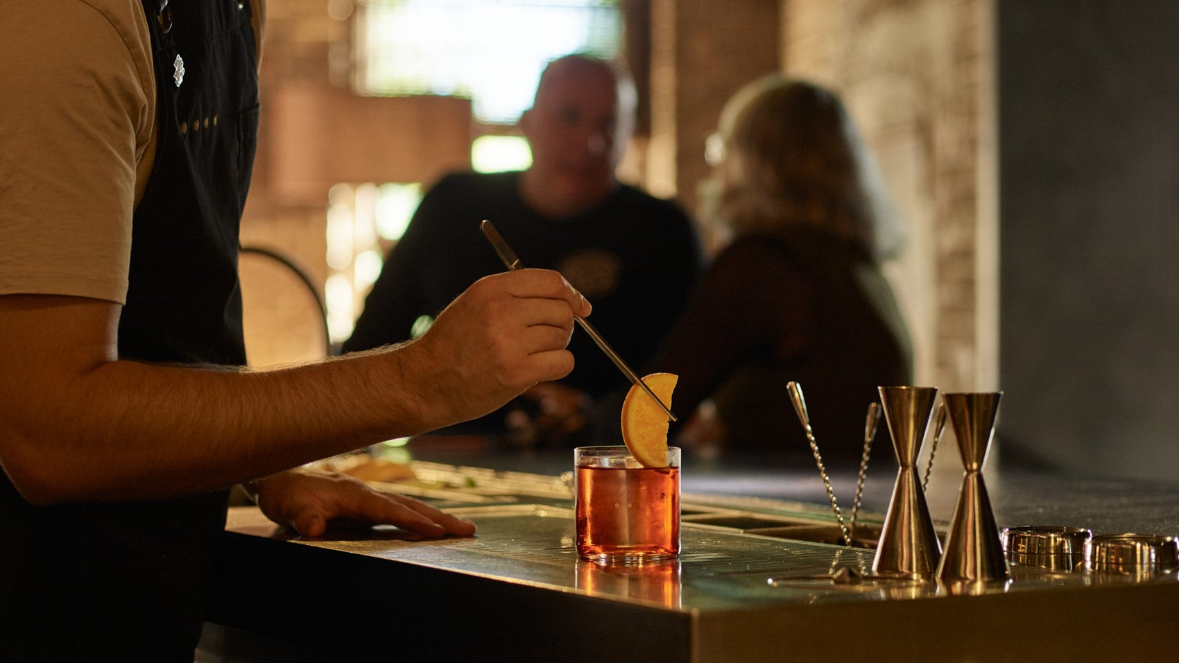 An orange is garnished onto a Negroni at Eileen's Bar in the Four Pillars Laboratory in Sydney.