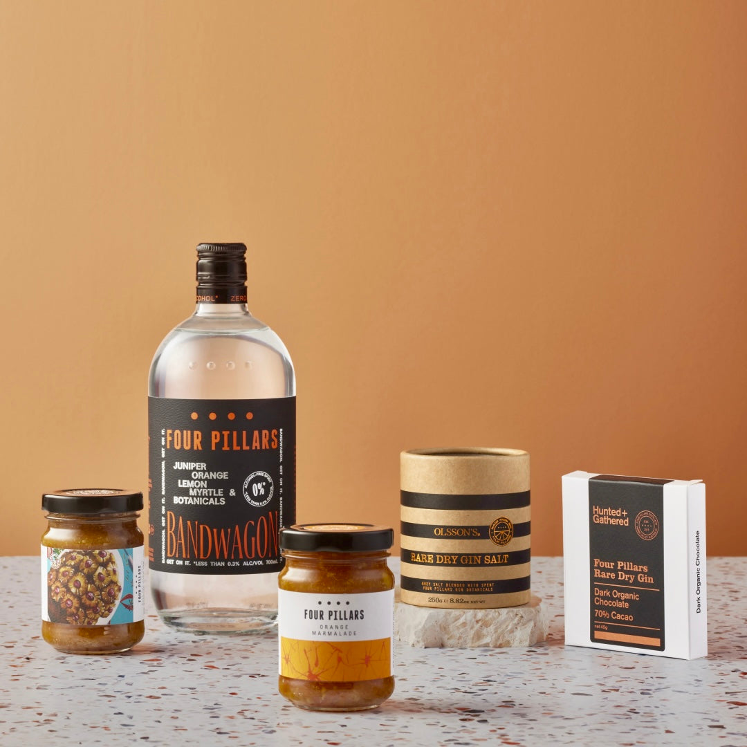 A Four Pillars Gin corporate gifting bundle that includes a non-alcoholic Rare Dry Gin and some sustainable and delicious made-from-gin goodies such as ham glaze, orange marmalade, salt, and chocolate. A great gift for any one who loves a zero alch spirit! 