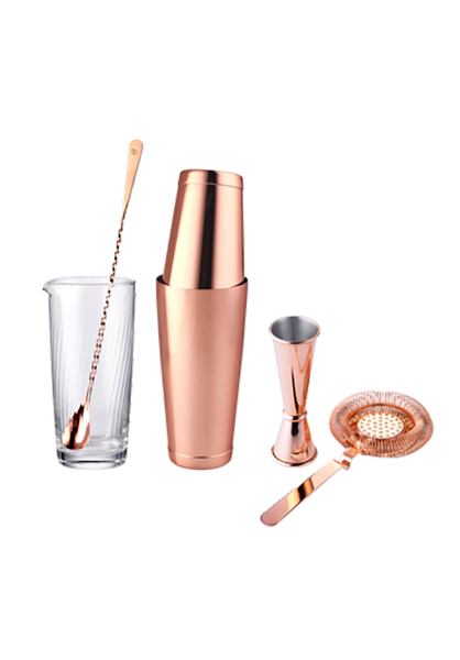 A collection of copper cocktail bar tools including a copper shaker alongside a stylish glass, showcasing elegant copper barware for mixology enthusiasts.