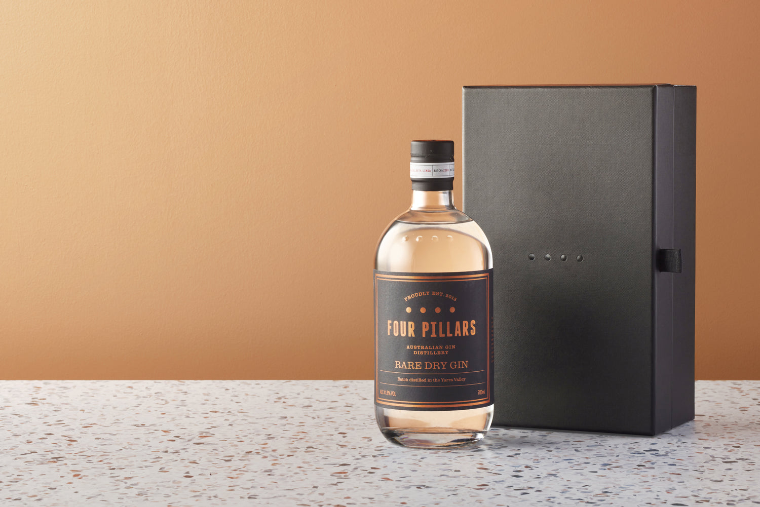 A bottle of Four Pillars Gin Rare Dry Gin besides a gift box available for corporate gifting.